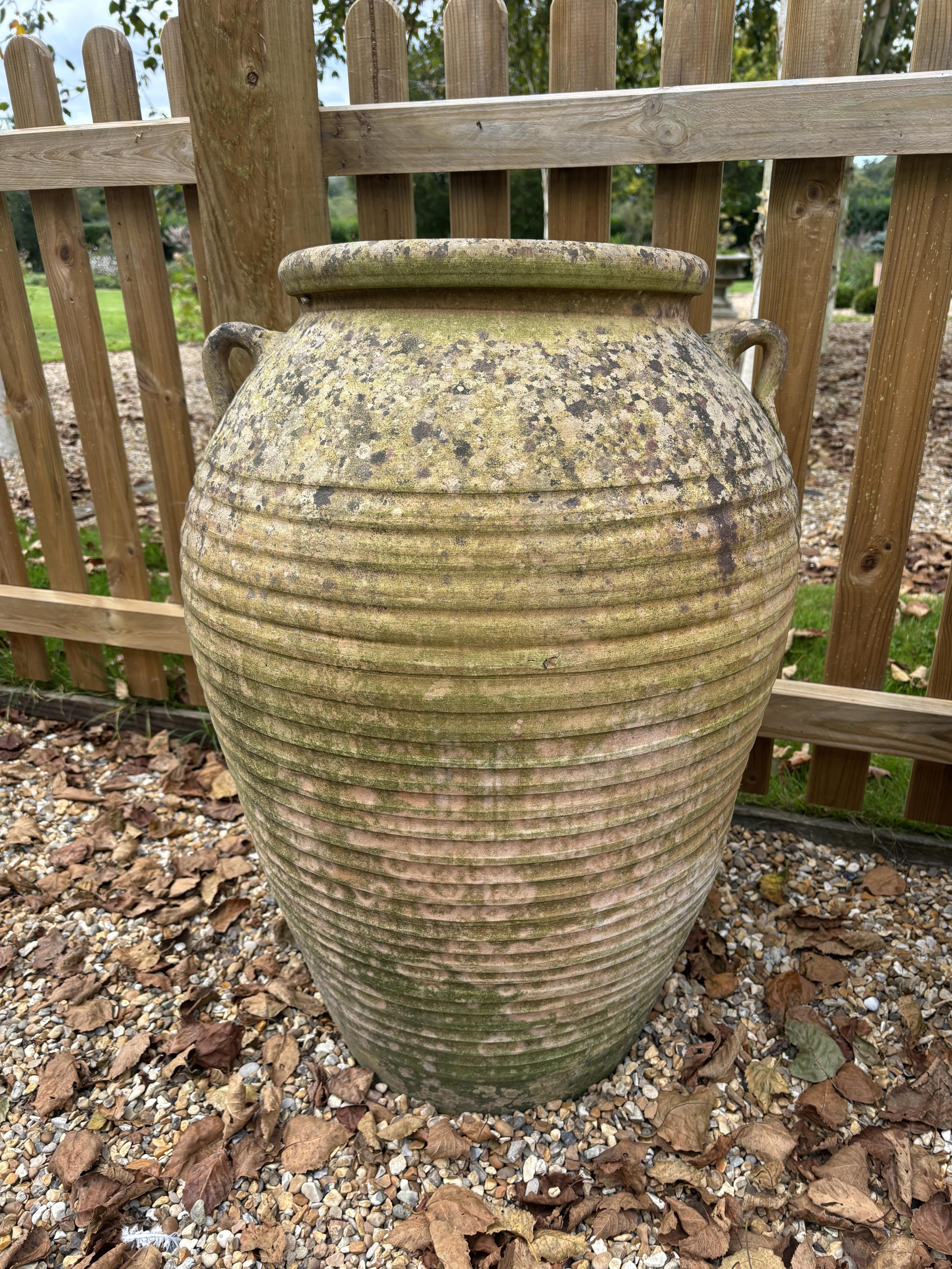 A pair of Italian style terracotta urns, height 75cm, width 48cm. Condition - weathered, otherwise good